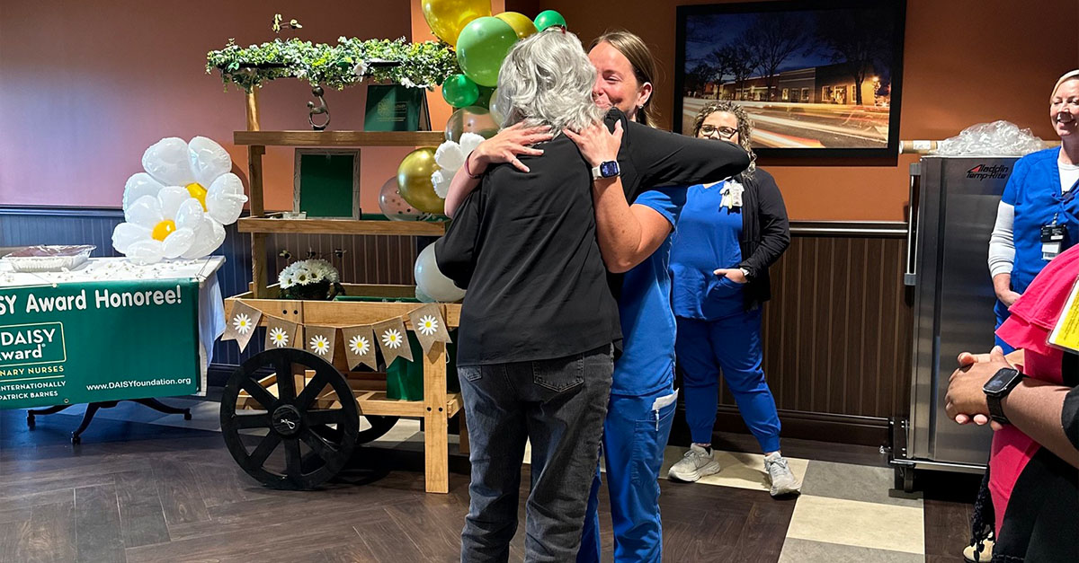 Natalie Stinnett hugging a person after receiving DAISY award 