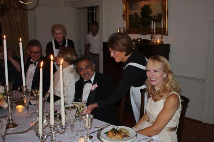 Sarah Burbach at a candlelight dinner with others.